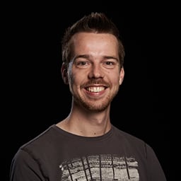 A headshot of an insanely handsome developer looking at the camera with a strapping smile.