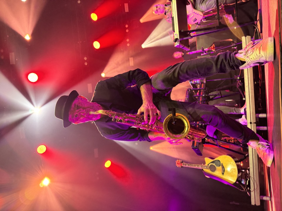 Saxophonist of the 'Edwin Evers Band' performing live on stage. He's looking into the camera